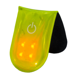 Close-up of yellow PVC reflective magnetic clip LED safety light with four LEDs and soft backing for secure attachment