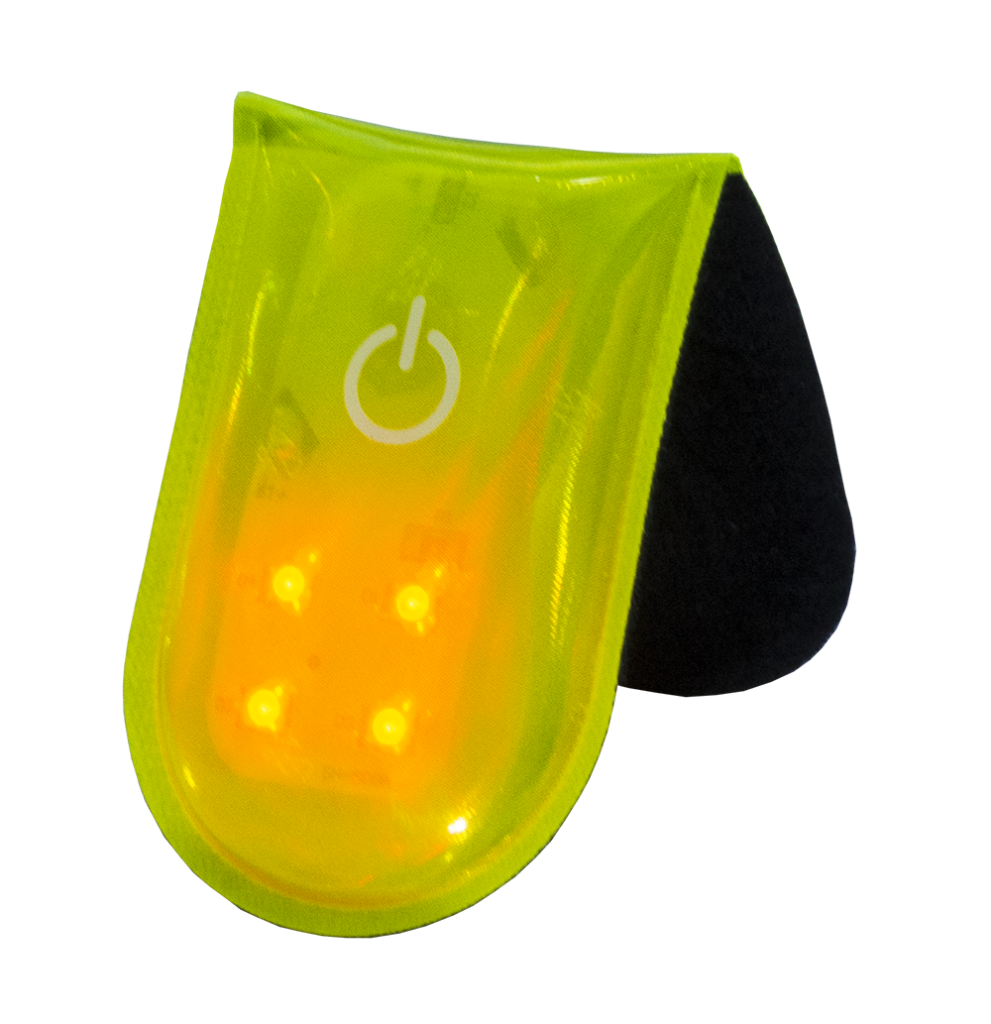 Close-up of yellow PVC reflective magnetic clip LED safety light with four LEDs and soft backing for secure attachment