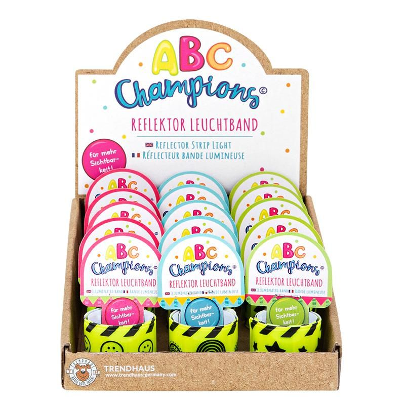 Retail display box of ABC Champions reflective snap wristbands with multiple colorful designs, ideal for schools, giveaways, promotions, and wholesale sales